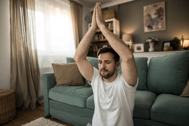 istock Relaxed mid adult man doing yoga at home. 2149331898