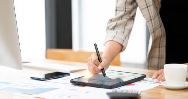 istock Close up of a female hand using digital tablet with a pen while working from home. Lifestyle and technology 2149336174
