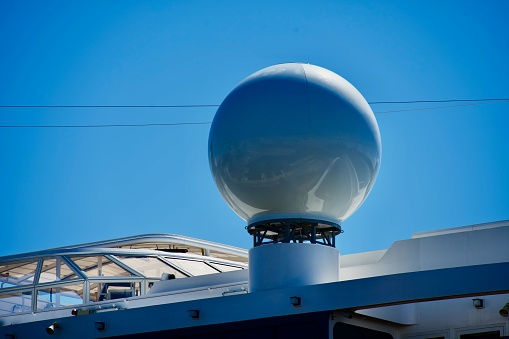 Norfolk, Virginia, USA - April 14, 2024: A large “golf ball” sits atop a Viking cruise ship docked at the Half Moone Cruise and Celebration Center in downtown Norfolk providing on-board communications.
