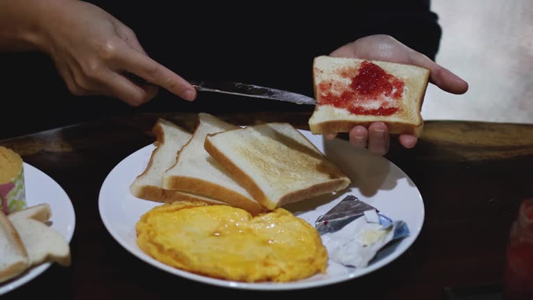 Preparing Toast with Jam and Butter