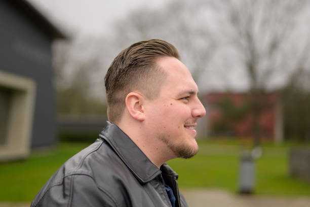 istock Side view of a young attractive man in his twenties looking friendly 2149340527