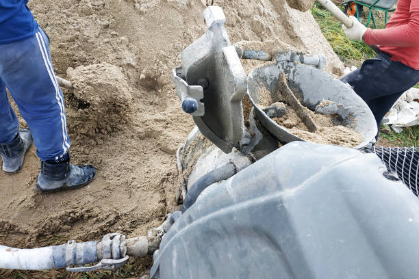 istock The worker mixes cement with sand in a concrete mixer. 2149343498