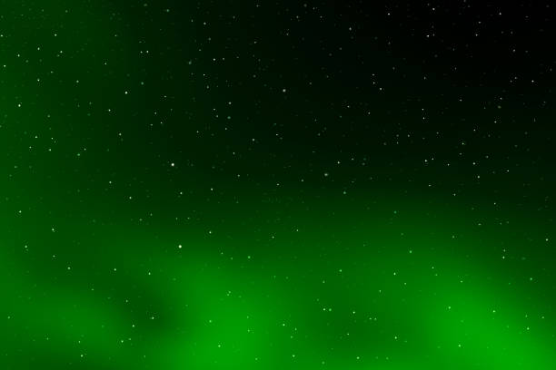Green galaxy space background. Starry night sky. Glowing sky in space. Celebration, New Year and Christmas backgrounds concept.