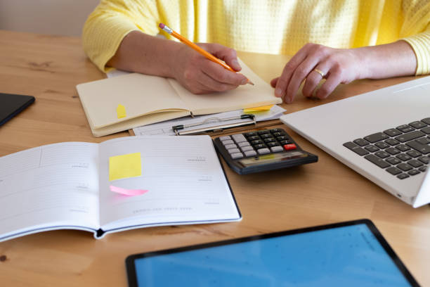 istock Woman At Home Using Home Financial Book. 2149346221