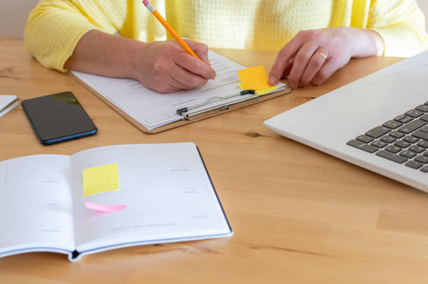 istock Independent Person Filling Out or Checking Documents. 2149346222