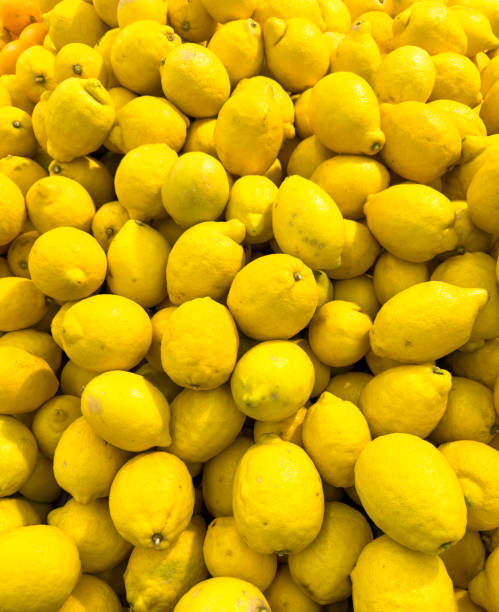 istock Yellow lemons on a counter in a market as an abstract background. Texture 2149346545