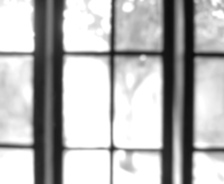 Photo of object framing blurry black and white window glass out of focus, glass out of focus on photo in glass frame at home