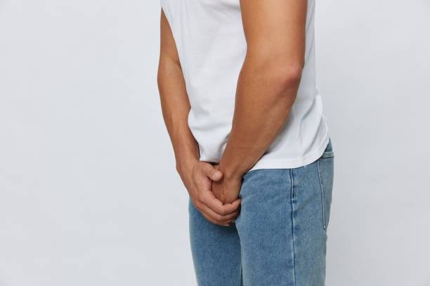 istock Man groin pain problems with potency and urination, urolithiasis, in white t-shirt on white isolated background, copy space 2149349738