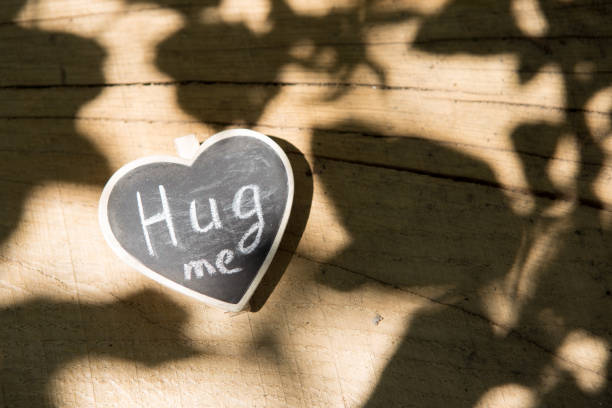 istock Hug me hand drawing phrase on a heart, Share a Hug Day concept 2149350275