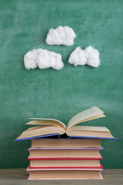 istock Education and reading creative concept - open under the cotton clouds book, inspiration for a fairy tale 2149350281
