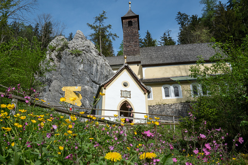 Summer flower meadow in front of the pilgrimage church Maria Klobenstein in the romantic breakthrough valley of the Großache in Tyrol, Austria