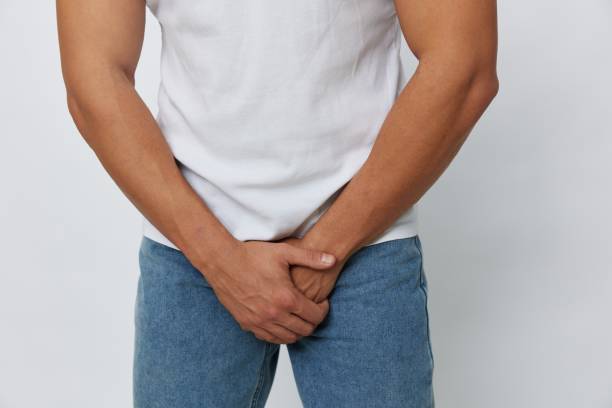istock Man groin pain problems with potency and urination, urolithiasis, in white t-shirt on white isolated background, copy space 2149351148