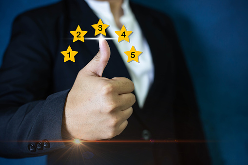 Customer service evaluation best excellent business rating experience concept. Man pressing five star in satisfaction on the virtual touch screen. Feedback survey quality rate, five star service