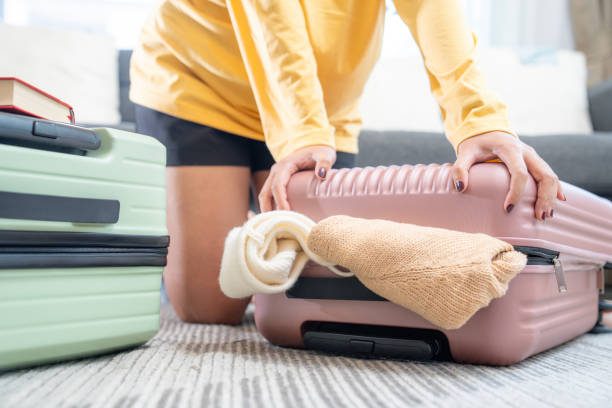 istock A woman preparing her travel bag 2149353599