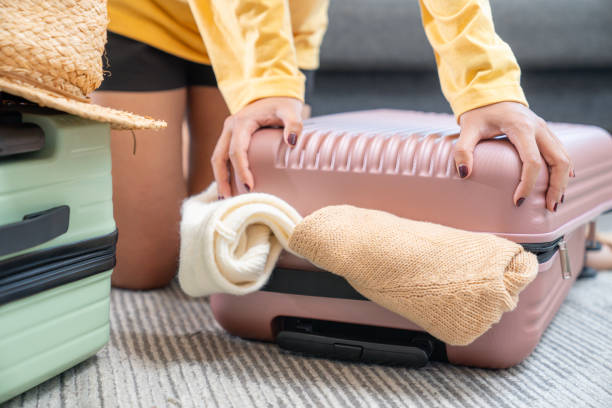 istock A woman preparing her travel bag 2149353600