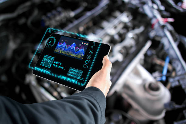 istock Car mechanic checking ECU electronic control unit with OBD or OBD2 wireless scanner tool , car information showing on screen interface 2149353677