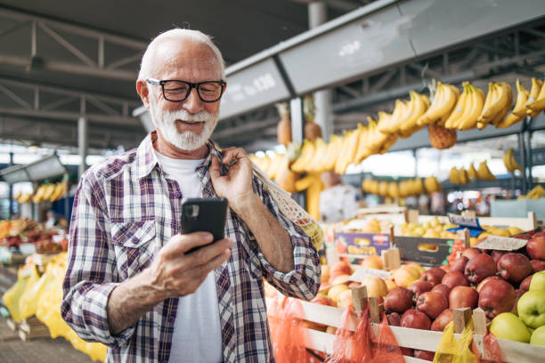 istock Smiling senior man at the market. 2149355757