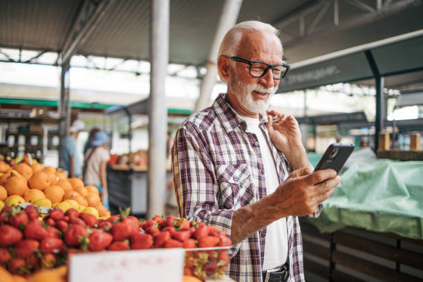 istock An elderly man as a buyer at the market. 2149355894