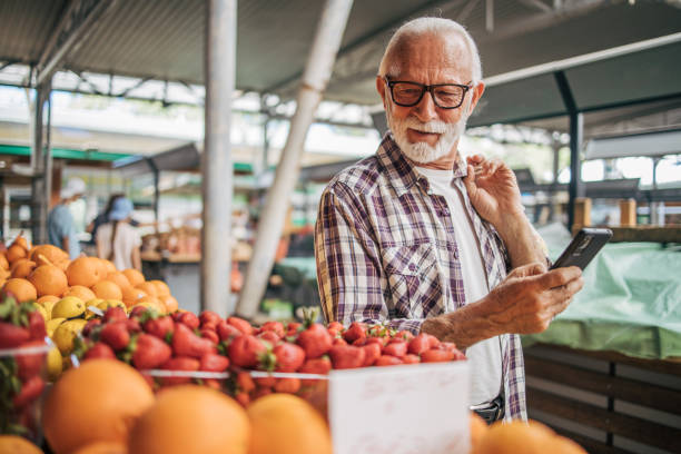 istock An elderly man as a buyer at the market. 2149356062