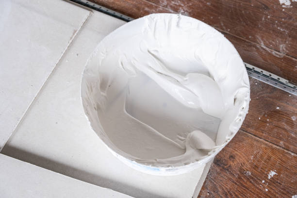 istock Applying decorative putty. White abstract texture of surface covered with putty 2149356251