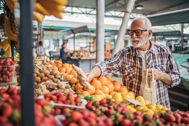 istock Relaxed senior man chooses organic fruit at the market. 2149356258