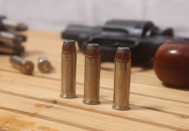 A black pistol. Traumatic pistol with cartridges lies on a white background