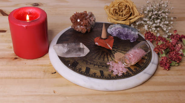 istock Pyramid With Crystals and Dried Flowers on Antique Sundial 2149357115