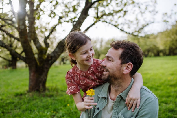 istock Father looking at his daughter lovingly in spring nature. Father's day concept. 2149357184