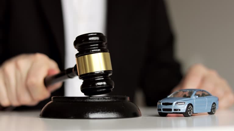 Car Accident Liability Insurance Lawyer And Gavel. Judge's hand banging a gavel.