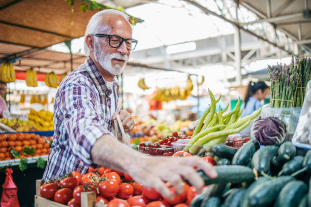 istock An elderly man sells organic vegetables at the market. 2149358380