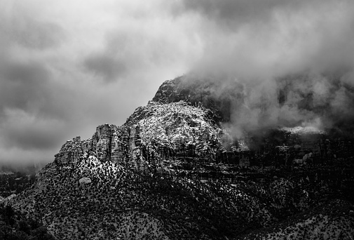 Clouded mountains of Zion National Park, Utah in the dead of a winter storm. Taken in Monochrome.