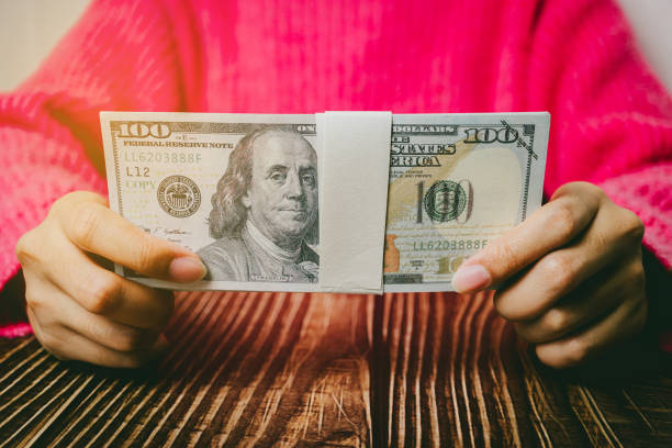 istock Female hands holding banknotes, finance concept 2149360496