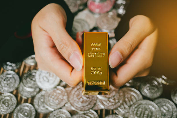 istock A woman's hand is holding a gold bar. 2149360692