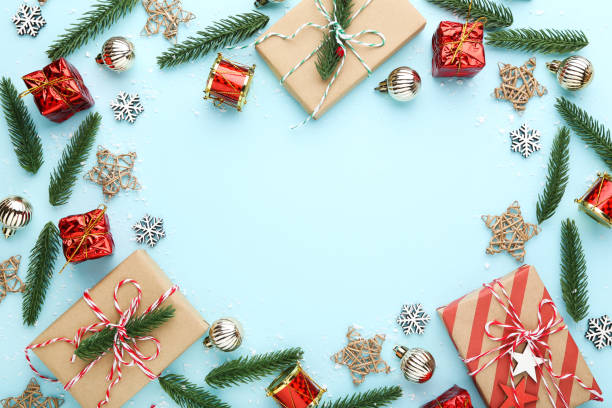 istock Christmas composition. Fir tree branches with ornaments and gift boxes on blue background 2149361167