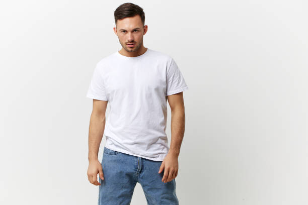 istock Serious angry young tanned handsome man in basic t-shirt look at camera posing isolated on over white studio background. Copy space Banner Mockup. People emotions Lifestyle concept 2149362108