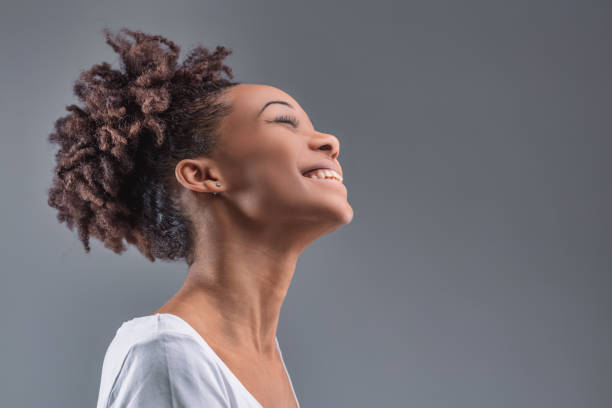 istock Black Woman's head back, laughing in pure joy 2149362419