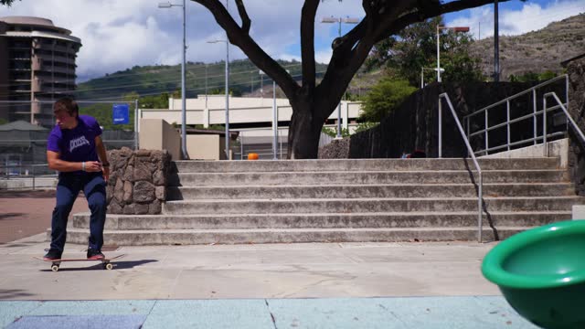 Skater does a trick down some stairs in Hawaii