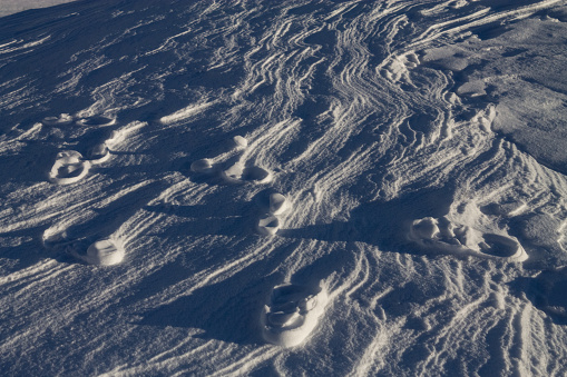Lunar landscape scene of footprints in the snow at high altitude