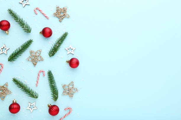 istock Christmas composition. Fir tree branches with ornaments on blue background 2149362978