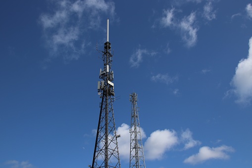 GPS antenna mast against blue sky with space for edit.Mobile internet station  in rural Britain.Connectivity UK.Mobile reception on british countryside.