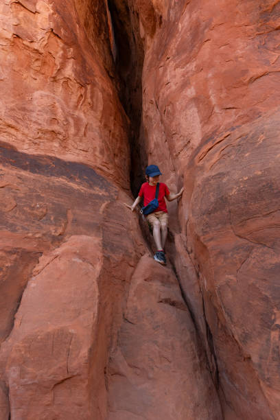 istock Boy Climbing Rocks in Arches National Park, Utah 2149365483