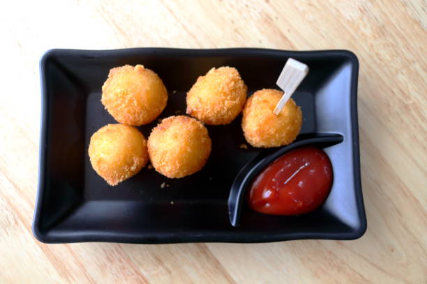 istock Fried cheese ball on black dish with tomato sauce. 2149366628