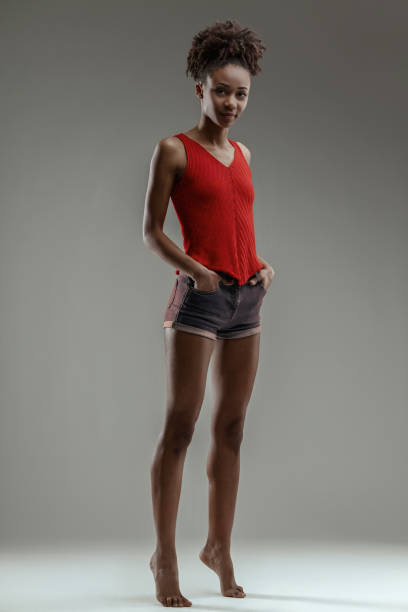 istock Hands on hips, young black woman tiptoeing 2149366645