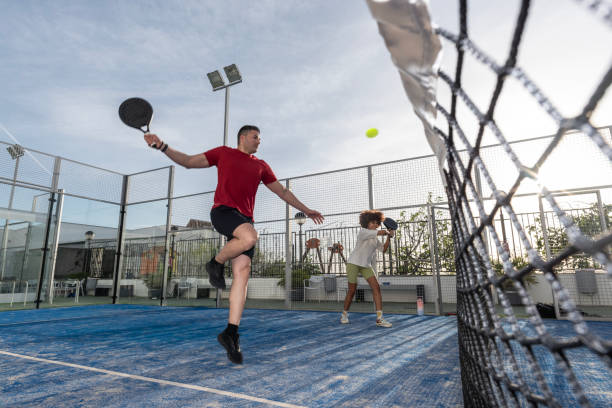 istock wide angle image of paddle tennis player smashing 2149368113