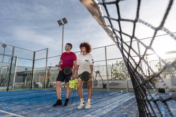 istock wide angle image of diverse paddle tennis couple 2149368115