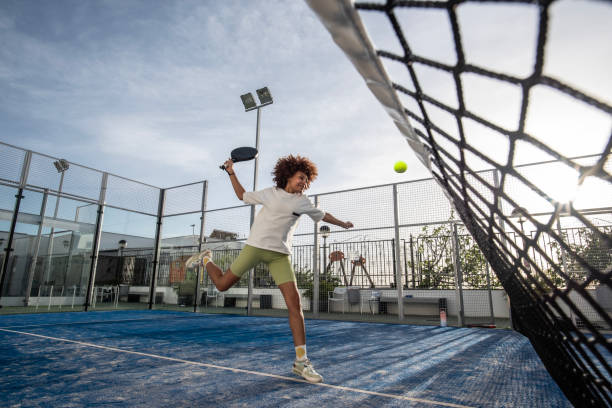 istock wide angle image of paddle tennis player smashing 2149368119