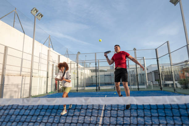istock Couple playing paddle tennis in court 2149368158