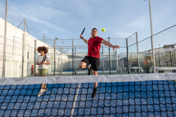 istock Couple playing paddle tennis in court 2149368171