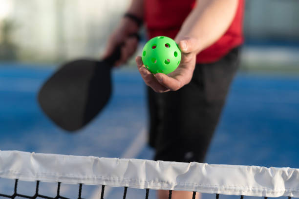 istock Man playing pickleball in court: pickle ball serving 2149368382