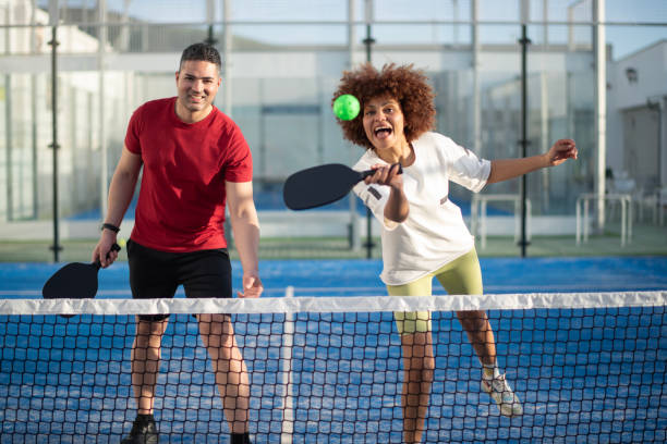 istock Couple playing pickleball in court 2149368385